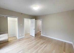 Edmonton apartment for rent - a living room with a hard wood floor and a mirrored closet