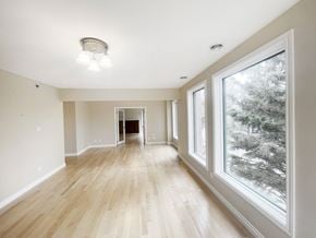 Edmonton apartment for rent - an empty living room with large windows and wood floors