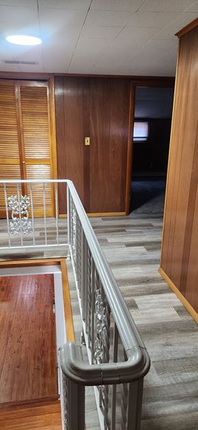 Lima house for rent - a view of a staircase in a building with wood and stainless steel railing