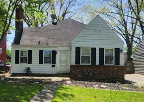 Lima house for rent - a white house with black shutters and a brick sidewalk