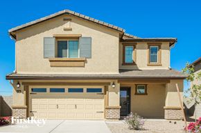 Buckeye house for rent - a tan house with a garage door