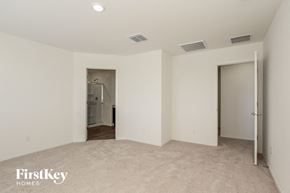 Buckeye house for rent - a bedroom with a closet and a door to a bathroom
