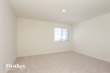 Buckeye house for rent - a spacious living room with carpet and a window