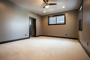Bozeman apartment for rent - an empty room with a ceiling fan and a window