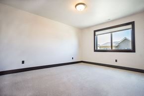 Bozeman apartment for rent - a empty room with a window and a white carpet