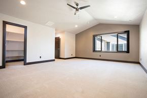 Bozeman apartment for rent - an empty living room with a ceiling fan and a window