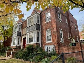Washington apartment for rent - a red brick house with white windows and a fence