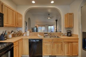 Pagosa Springs house for rent - a kitchen with wooden cabinets and a dishwasher and a sink