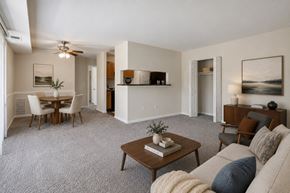 Laurel apartment for rent - A living room with a couch, coffee table, and a dining table.