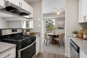 Laurel apartment for rent - A modern kitchen with a black stove top oven and white cabinets.