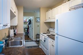 Fruitvale apartment for rent - A kitchen with white cabinets and a white refrigerator.