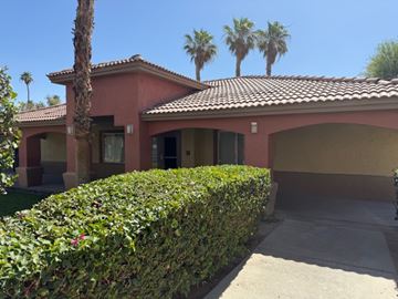 Coachella multi-family for rent - A red house with a palm tree in front.
