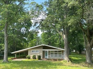 Charlotte house for rent - a small house with trees in front of it