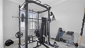 Spring Lake house for rent - a home gym with weights and equipment in the corner of a room