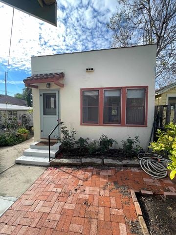 San Luis Obispo apartment for rent - A small white house with a red door and windows.