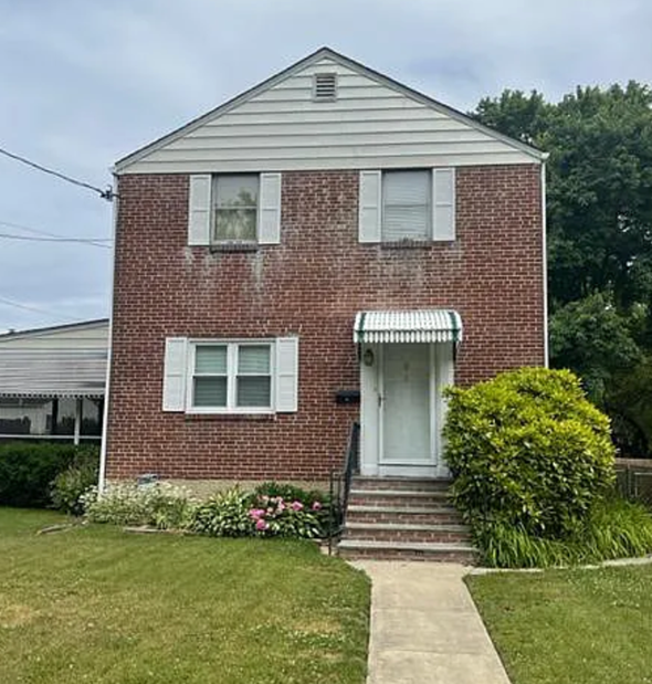 Wilmington house for rent - A red brick house with a white door and windows.
