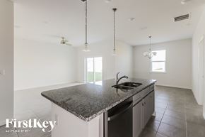 Bartow house for rent - a large kitchen with granite counter tops and a sink