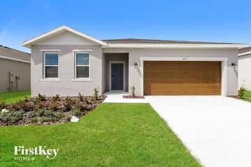 Bartow house for rent - a house with a garage door and a lawn