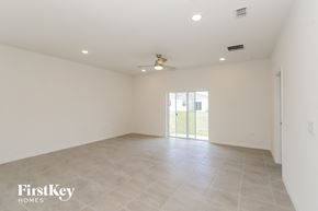 Bartow house for rent - an empty living room with white walls and a sliding glass door