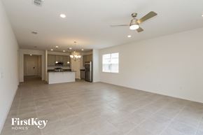 Bartow house for rent - an empty living room and kitchen with a ceiling fan