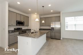 Bartow house for rent - a large kitchen with stainless steel appliances and granite counter tops