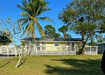 Stuart apartment for rent - a white house with a palm tree in front of it