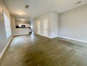 New Albany apartment for rent - an empty living room and kitchen with white walls and wooden floors