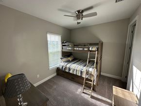 Palmetto house for rent - a bedroom with a bunk bed and a ceiling fan