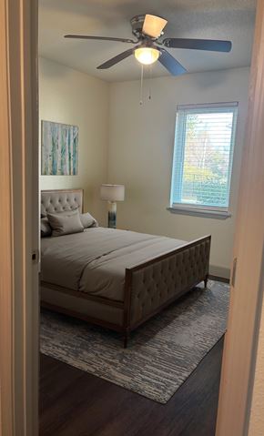 Canton apartment for rent - A bedroom with a bed, a ceiling fan, and a window.