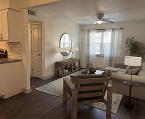 Canton apartment for rent - A living room with a wooden floor and furniture.