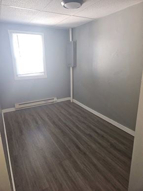 Lima apartment for rent - an empty room with wooden floors and a window