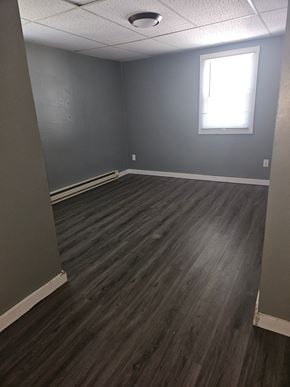 Lima apartment for rent - an empty room with wooden floors and a window