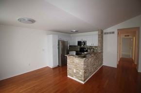 Shelby Township house for rent - an empty living room with a stone island in the middle of it