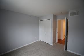 Shelby Township house for rent - a bedroom with grey walls and a white door