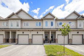 Arnprior house for rent - a white and tan house with two garage doors