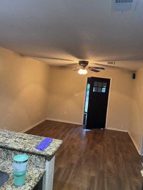 Pasadena house for rent - an empty living room with a ceiling fan and wood floors