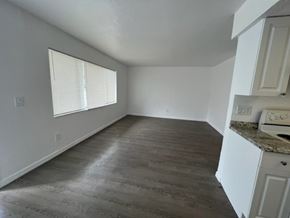 Fort Myers apartment for rent - A room with a window and a counter with a toaster and a microwave.