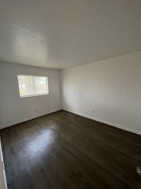 Fort Myers apartment for rent - A room with a window and wooden flooring.