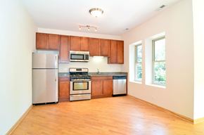 Chicago apartment for rent - A kitchen with wooden cabinets and stainless steel appliances.