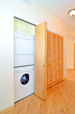 Chicago apartment for rent - A white dryer and washer are in a small laundry room.