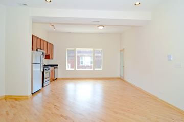 Chicago apartment for rent - A kitchen with a refrigerator, oven, and sink is shown.