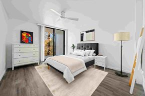 Sacramento apartment for rent - a white bedroom with a bed and a ceiling fan