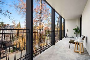Sacramento apartment for rent - a balcony with a table and chairs and a large window