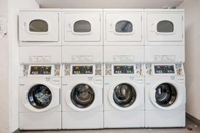 Miami apartment for rent - a row of white washing machines in a laundry room