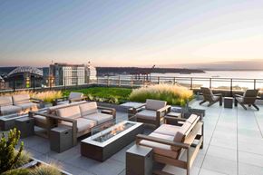 Seattle apartment for rent - a rendering of a rooftop terrace with furniture and a fire pit
