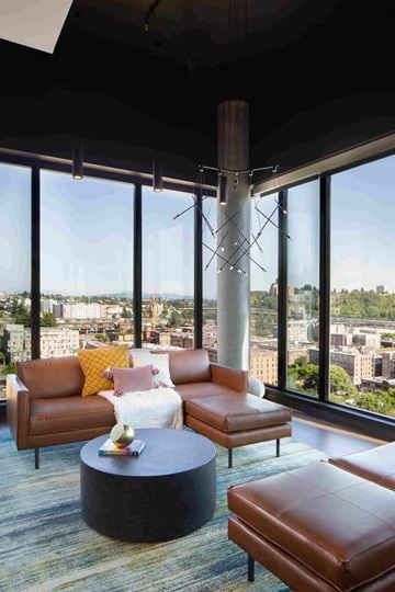 Seattle apartment for rent - a living room in a skyscraper with couches and a table