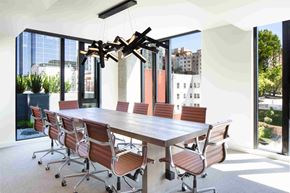 Seattle apartment for rent - a dining room with a long table and chairs and a chandelier