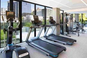 Seattle apartment for rent - a gym with cardio equipment and a view of the city