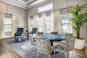 Daytona Beach apartment for rent - A modern dining room with a round table and zebra print chairs.
