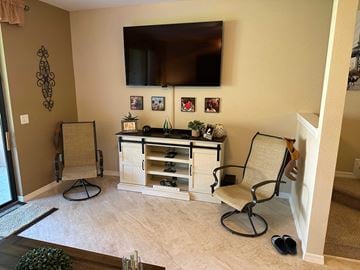 Bradenton house for rent - a living room with two chairs and a tv